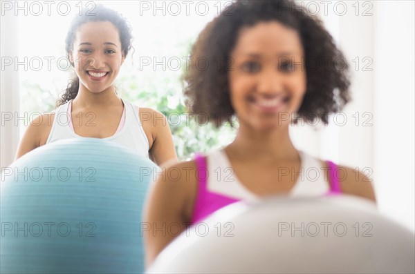 Women working out with fitness balls in exercise class