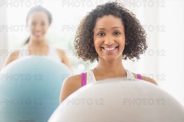 Women working out with fitness balls in exercise class