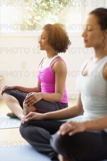 Women meditating in yoga class