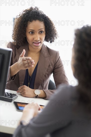 Businesswomen talking in office meeting