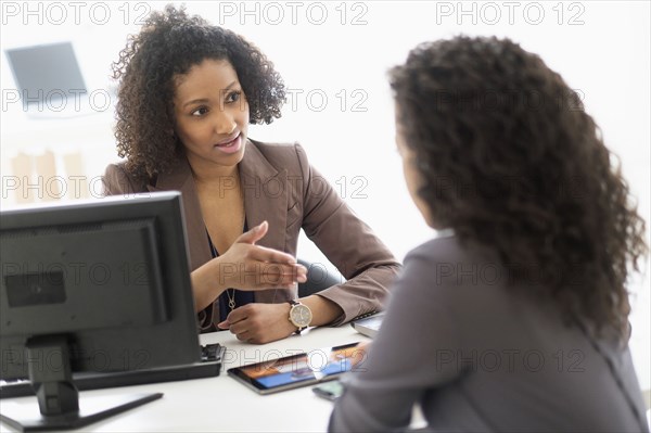 Businesswomen talking in office meeting