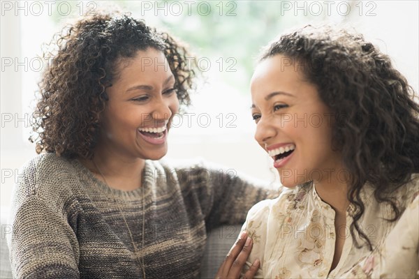 Laughing women relaxing on sofa