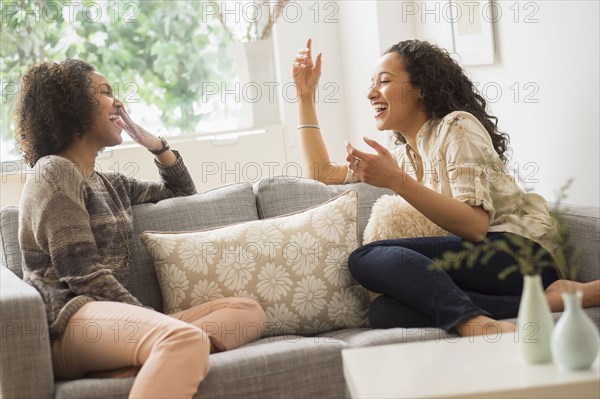 Laughing women relaxing on sofa