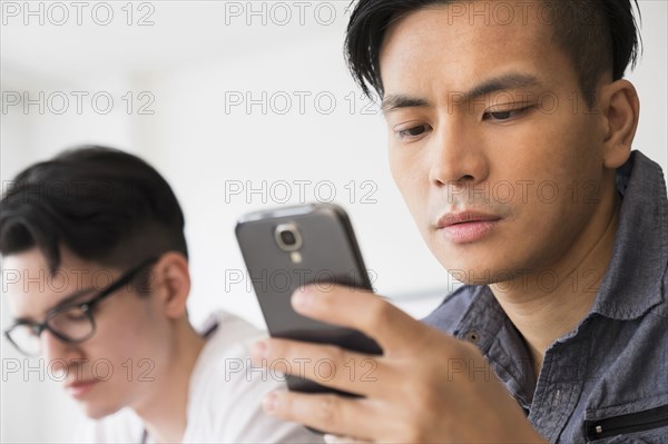Close up of serious man texting on cell phone