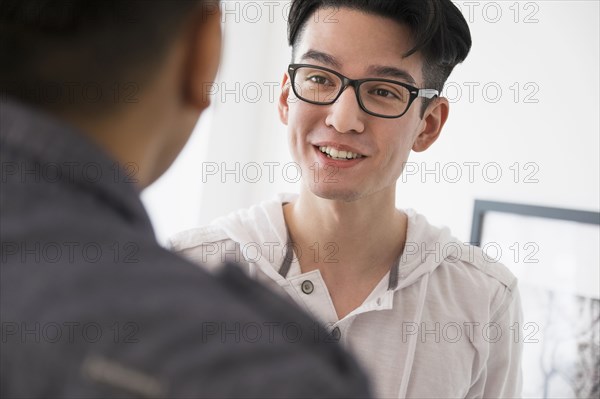 Close up of smiling men talking