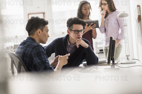 Businessmen working together in office