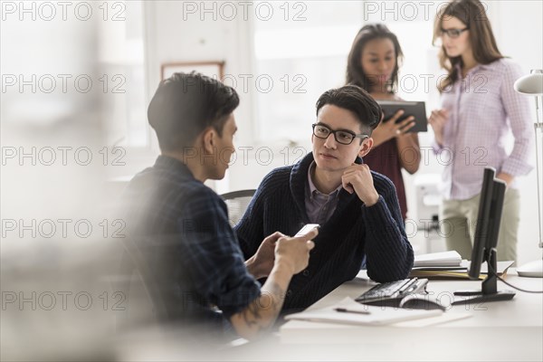 Businessmen working together in office