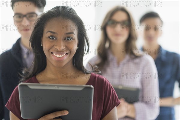 Close up of smiling businesswoman holding digital tablet in office