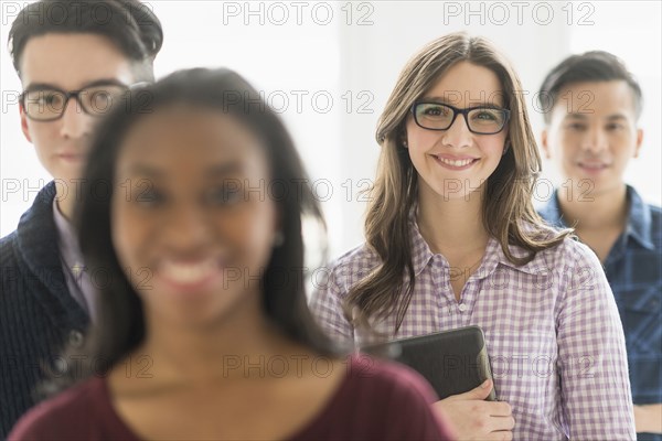 Smiling businesswoman holding digital tablet in office