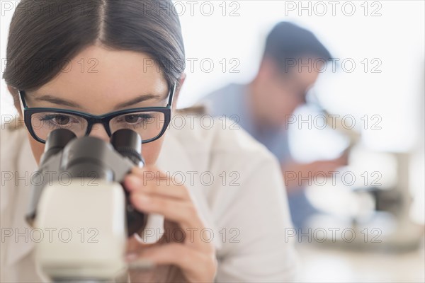 Scientist using microscope in research laboratory