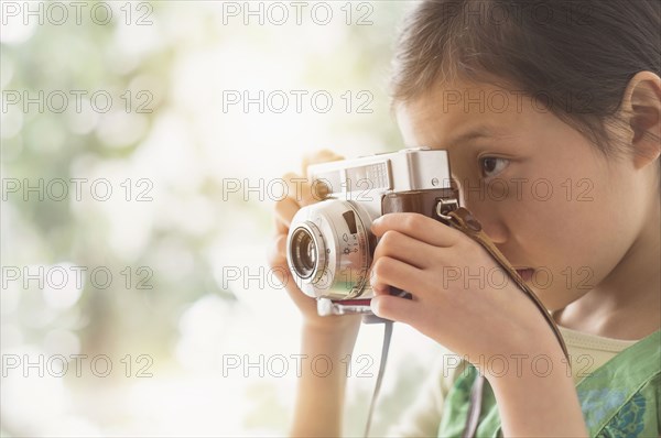 Chinese girl photographing with vintage camera