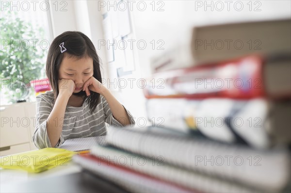 Chinese student thinking about homework