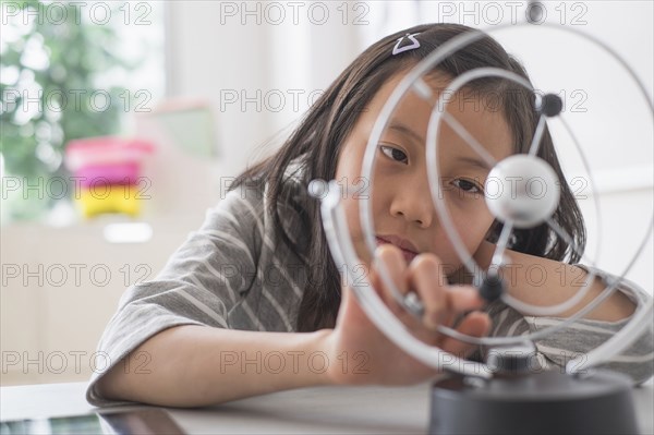 Chinese student examining molecular model