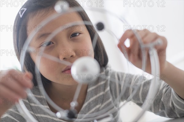 Chinese student examining molecular model