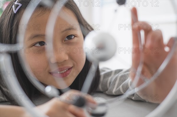 Chinese student examining molecular model