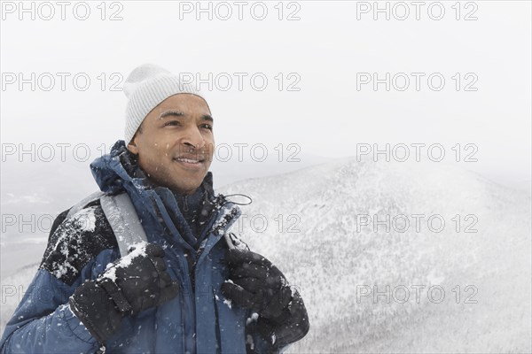 Black man hiking in snow