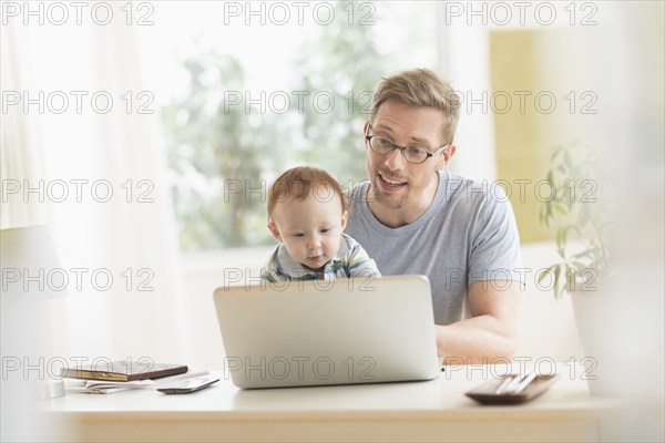 Caucasian father and baby using laptop