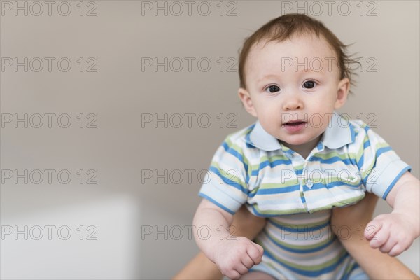 Father lifting Caucasian baby