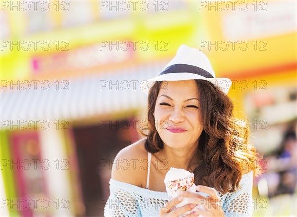 Chinese woman eating ice cream cone