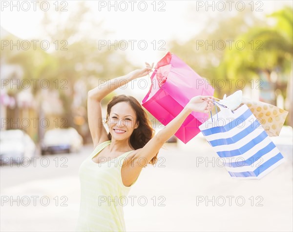 Chinese woman carrying shopping bags outdoors