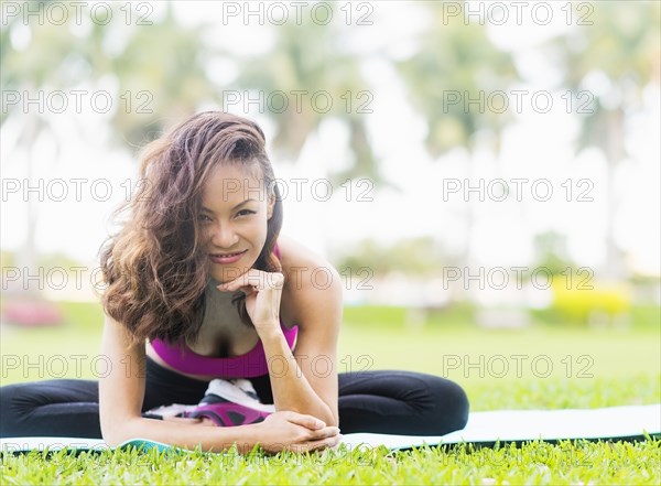 Chinese woman stretching in park