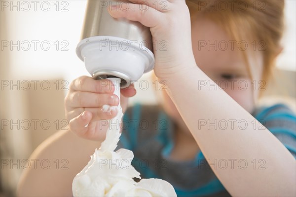 Caucasian girl spraying whipped cream