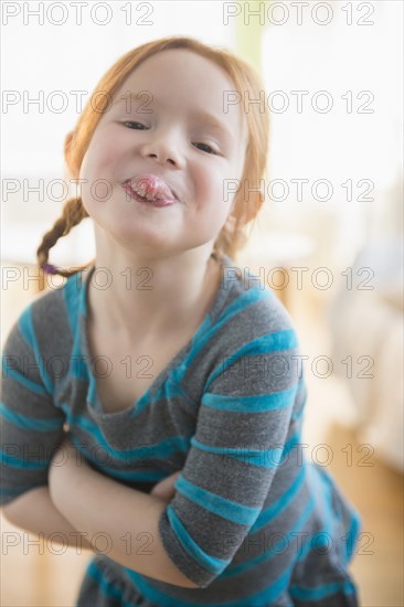 Defiant Caucasian girl sticking out tongue