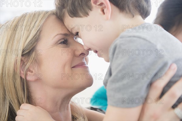 Close up of Caucasian mother and son touching forehead
