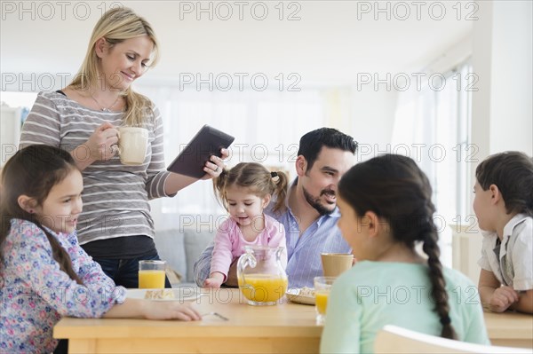 Caucasian family eating breakfast at table