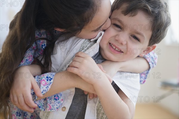 Close up of Caucasian girl kissing brother