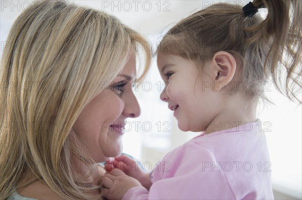 Close up of Caucasian mother holding daughter