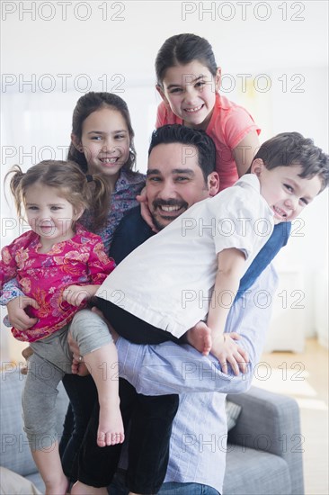 Caucasian father and children relaxing in living room