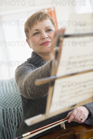 Caucasian violinist writing on sheet music