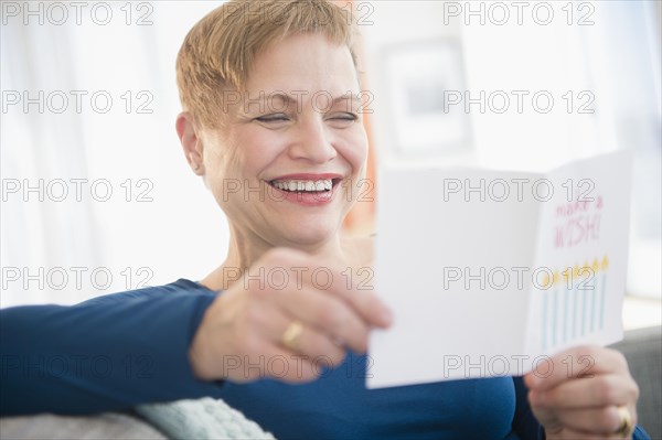 Caucasian woman reading birthday card