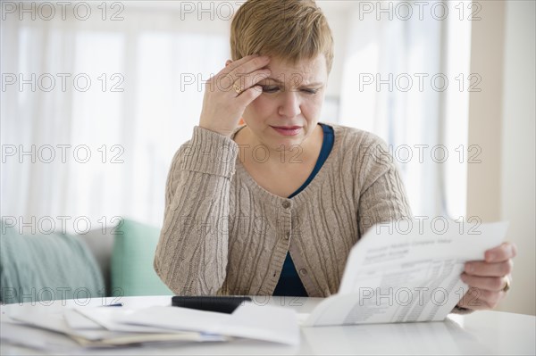 Anxious Caucasian woman paying bills