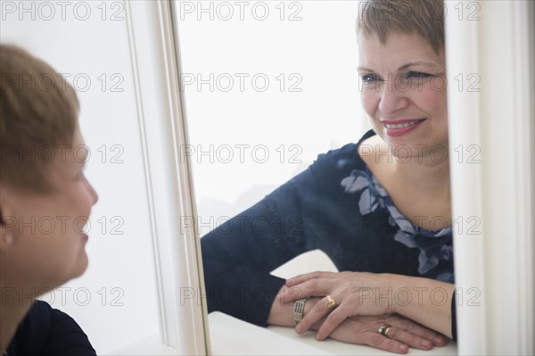 Caucasian woman admiring herself in mirror