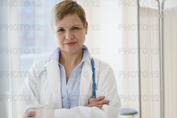 Caucasian doctor standing with arms crossed