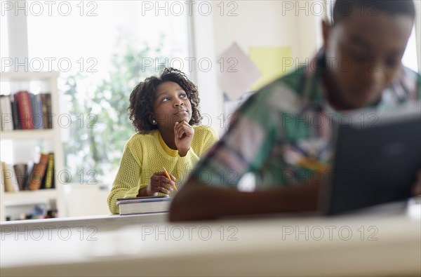 Black student thinking in classroom