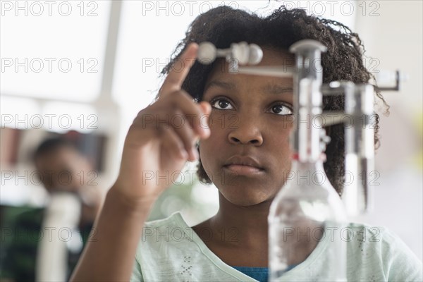 Black student doing experiment in science lab