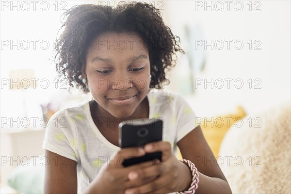 Close up of Black girl using cell phone