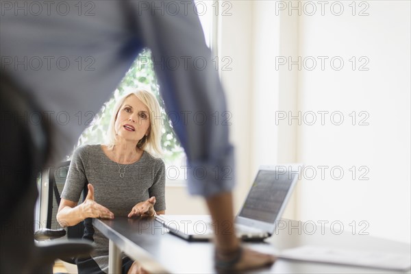 Older Caucasian business people arguing in office meeting