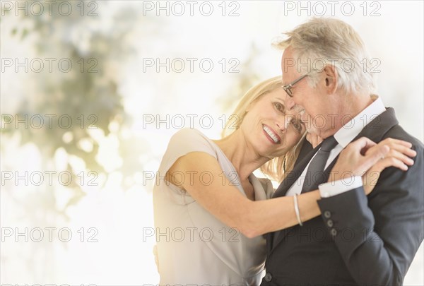 Smiling older Caucasian couple dancing