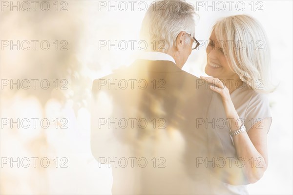 Smiling older Caucasian couple dancing