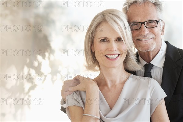 Smiling older Caucasian couple hugging