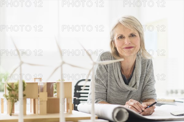 Older Caucasian architect sitting in office