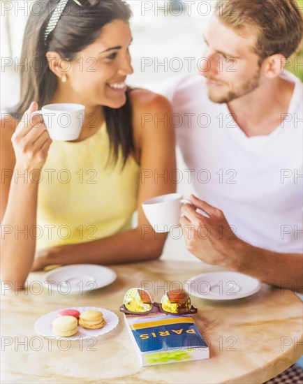 Hispanic couple having coffee at cafe