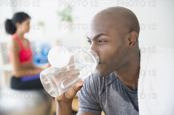 Close up of man drinking water bottle