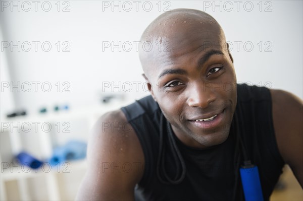 Black man resting in gym