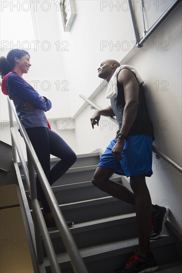 Couple talking on staircase after exercise