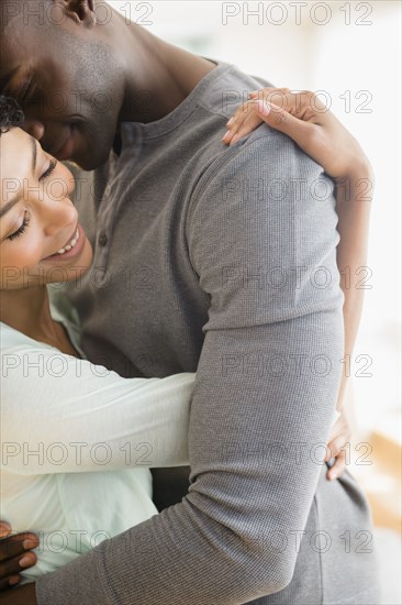 Close up of smiling couple hugging